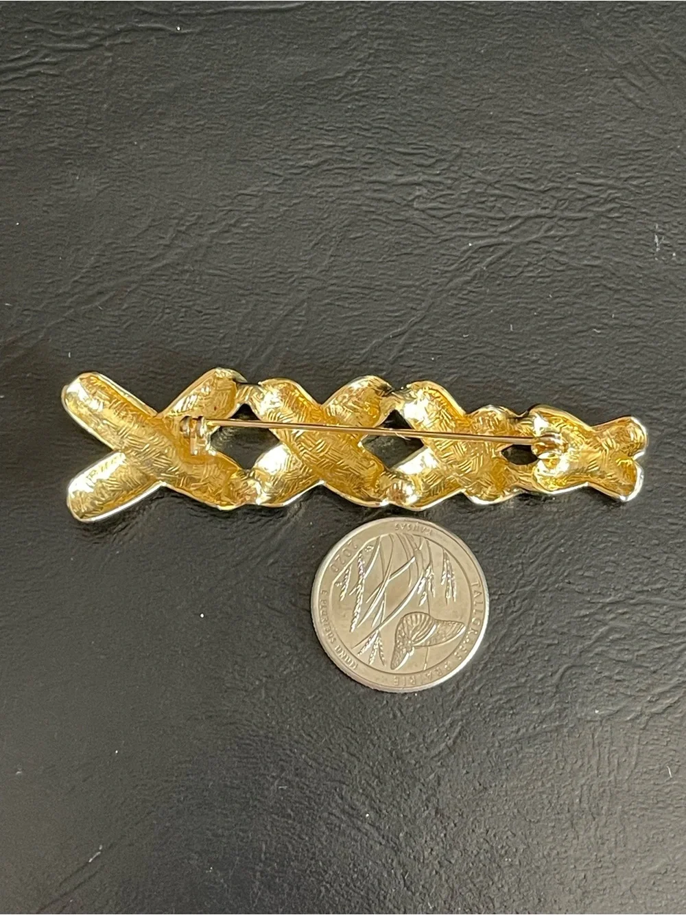 Vintage gold tone xxxx brooch.